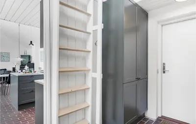 a kitchen with a walk in pantry and a door at Beautiful Home In Pandrup With Wifi in Pandrup