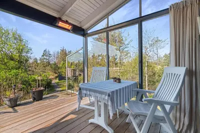 a table and two chairs on a deck at Beautiful Home In Blokhus With 1 Bedrooms in Blokhus