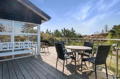 a patio with chairs and a table on a deck at Beautiful Home In Blokhus With 1 Bedrooms in Blokhus
