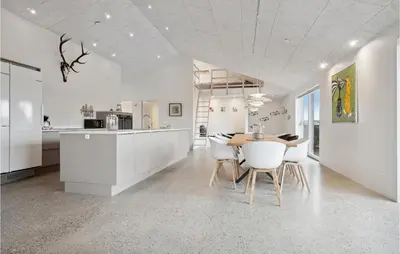 a kitchen and dining room with a table and chairs at Nice Home In Thisted With Sauna in Thisted