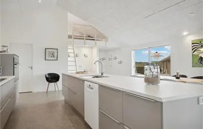 a large white kitchen with a sink and a window at Nice Home In Thisted With Sauna in Thisted