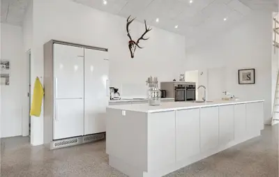 a white kitchen with white cabinets and a counter at Nice Home In Thisted With Sauna in Thisted