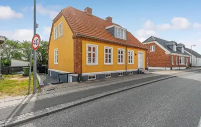 a yellow house on the side of a street at Stunning Home In Vestervig With Wifi in Vestervig