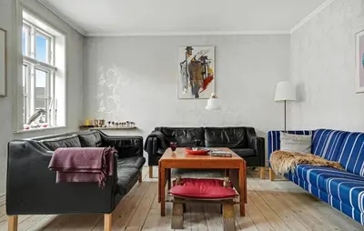a living room with black leather couches and a table at Stunning Home In Vestervig With Wifi in Vestervig