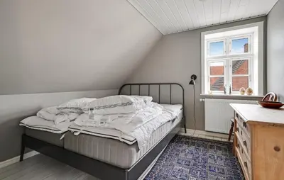 a small bedroom with a bed and a window at Stunning Home In Vestervig With Wifi in Vestervig