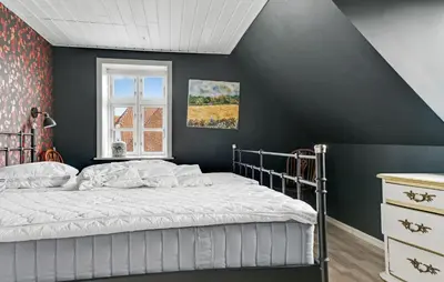 a bedroom with a bed with a black wall at Stunning Home In Vestervig With Wifi in Vestervig