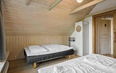 two beds in a room with wooden walls at 2 Bedroom Gorgeous Apartment In Pandrup in Pandrup