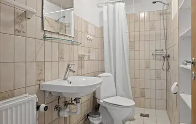 a bathroom with a sink and a toilet and a shower at 2 Bedroom Gorgeous Apartment In Pandrup in Pandrup