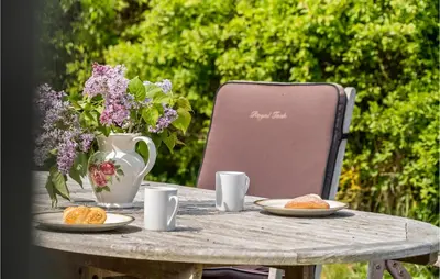 a table with plates of food and a vase of flowers at Beach Front Home In Lemvig With Wifi in Lemvig