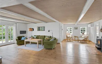 a living room with a couch and a table at Beach Front Home In Lemvig With Wifi in Lemvig