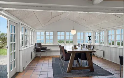 a dining room with a table and chairs at Beach Front Home In Lemvig With Wifi in Lemvig