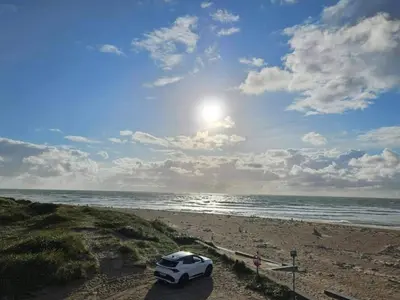 a white car parked on a beach near the ocean at 6 person holiday home in Thisted-By Traum in Torsted