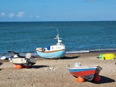 a group of boats sitting on the beach at 6 person holiday home in Thisted-By Traum in Torsted