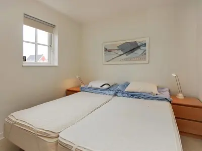 a bedroom with a bed and a window at Holiday Home Alita - 1-2km from the sea by Interhome in Blokhus