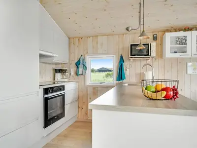 a kitchen with a bowl of fruit on a counter at Holiday Home Syni - 500m from the sea by Interhome in Pandrup