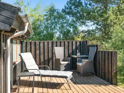 a deck with chairs and a table on a fence at Holiday Home Kali - 900m to the fjord by Interhome in Løgstør