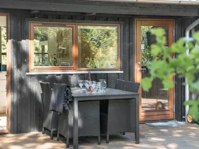 a table and chairs in front of a house at Holiday Home Kali - 900m to the fjord by Interhome in Løgstør