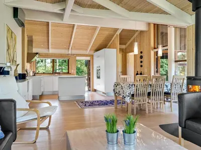 a kitchen and living room with a table and chairs at Holiday Home Kali - 900m to the fjord by Interhome in Løgstør