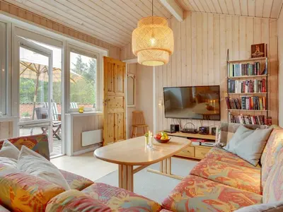 a living room with a couch and a table at Holiday Home Lisemarie - 800m from the sea by Interhome in Torsted