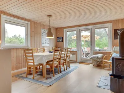 a kitchen and dining room with a table and chairs at Holiday Home Lisemarie - 800m from the sea by Interhome in Torsted