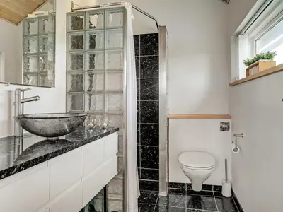 a bathroom with a sink and a toilet at Holiday Home Ejvind - 100m from the sea by Interhome in Saltum