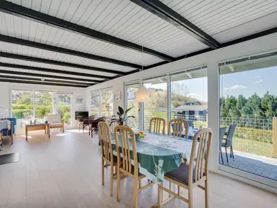 a dining room with a table and chairs at Holiday Home Vasilij - 300m to the fjord by Interhome in Farsø