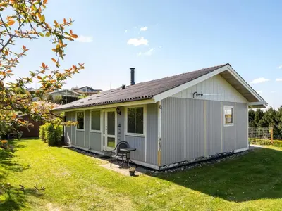 a gray house with a yard at Holiday Home Vasilij - 300m to the fjord by Interhome in Farsø