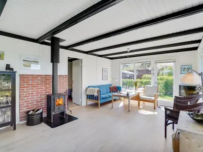 a living room with a fireplace and a couch at Holiday Home Vasilij - 300m to the fjord by Interhome in Farsø