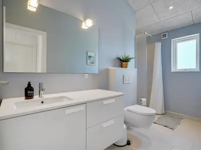 a bathroom with a white sink and a toilet at Holiday Home Grimar - 600m from the sea by Interhome in Torsted