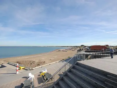 a boardwalk leading to a beach with people on it at Holiday Home Grimar - 600m from the sea by Interhome in Torsted
