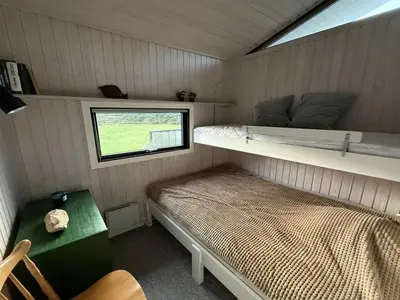 a small room with a bed and a window at Holiday Home Glenda - 3km from the sea by Interhome in Saltum