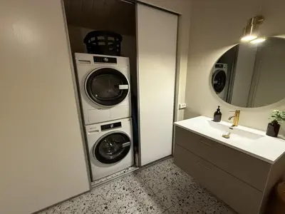 a bathroom with a washing machine and a sink at Holiday Home Glenda - 3km from the sea by Interhome in Saltum