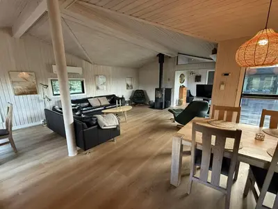a living room with a couch and a table at Holiday Home Glenda - 3km from the sea by Interhome in Saltum