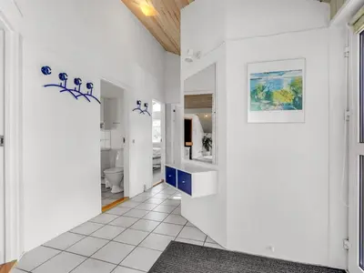 a bathroom with white walls and blue accents at Holiday Home Ritha - 350m from the sea by Interhome in Saltum