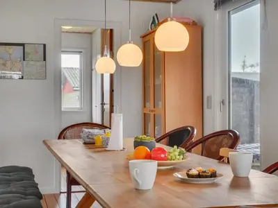 a dining room table with fruits on it with lights at Holiday Home Awer - 300m to the fjord by Interhome in Struer