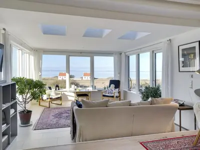 a living room with a couch and a view of the ocean at Holiday Home Aranja - 300m to the fjord by Interhome in Løgstør