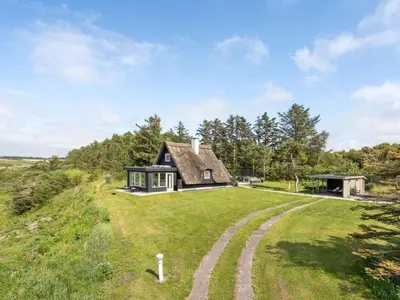 a house on the hill with a thatched roof at Holiday Home Aranja - 300m to the fjord by Interhome in Løgstør
