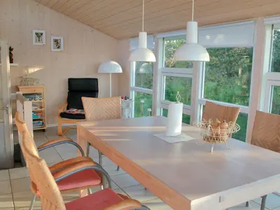 a dining room with a table and chairs at Holiday Home Annick - 300m from the sea by Interhome in Fjerritslev