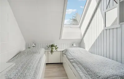two beds in a room with a window at Awesome Apartment In Blokhus With Wifi in Blokhus