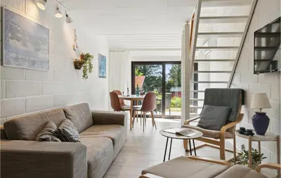 a living room with a couch and a table at Awesome Apartment In Blokhus With Wifi in Blokhus