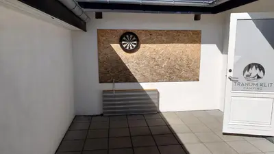 a room with a wheel on the wall at Tranum Klit Camping og Hytteudlejning in Brovst