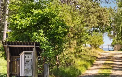 an old utility box sitting next to a dirt road at 3 Bedroom Awesome Home In Højslev in Højslev