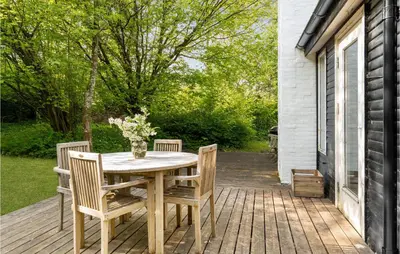 a wooden table and chairs on a deck at Awesome Home In Spøttrup With Wifi in Spottrup