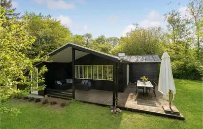a black shed with a table on a deck at Awesome Home In Spøttrup With Wifi in Spottrup