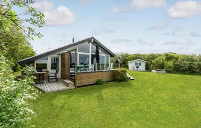 a modular home with a deck on a lawn at Stunning Home In Vestervig With Sauna in Vestervig