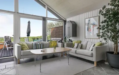 a living room with a couch and a table at Stunning Home In Vestervig With Sauna in Vestervig
