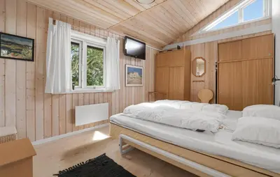 a bedroom with two beds and a window at Stunning Home In Vestervig With Sauna in Vestervig