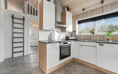 a kitchen with white cabinets and a stove at Stunning Home In Vestervig With Sauna in Vestervig