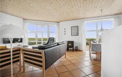 a living room with a couch and a table at 4 Bedroom Stunning Home In Thisted in Thisted